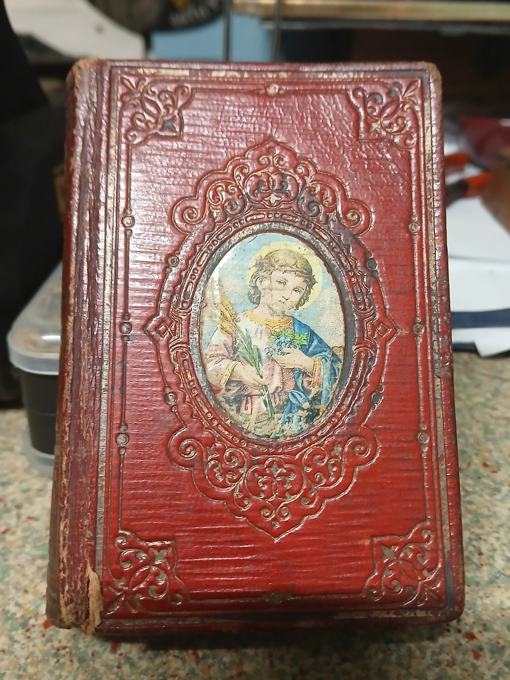 Vintage Red Embossed Holy Book with Saint Illustration
